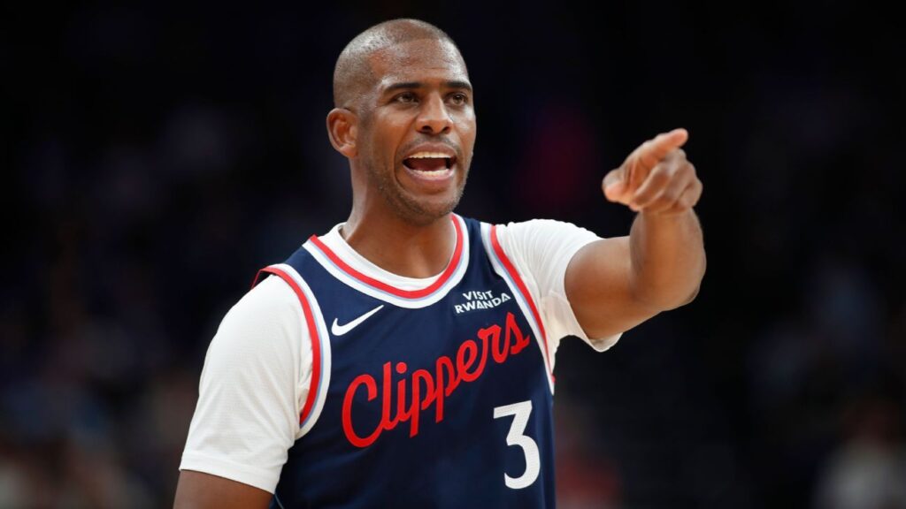 Chris Paul dribbling the basketball and directing play while wearing a Los Angeles Clippers jersey
