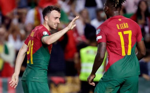 Rafael Leao looking towards the sky in tribute while wearing the Portugal national kit