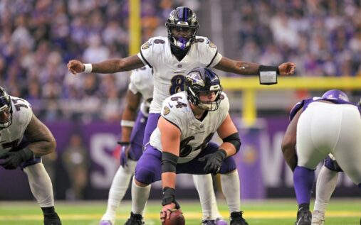Baltimore Ravens quarterback Lamar Jackson looking for a pass downfield during an NFL game
