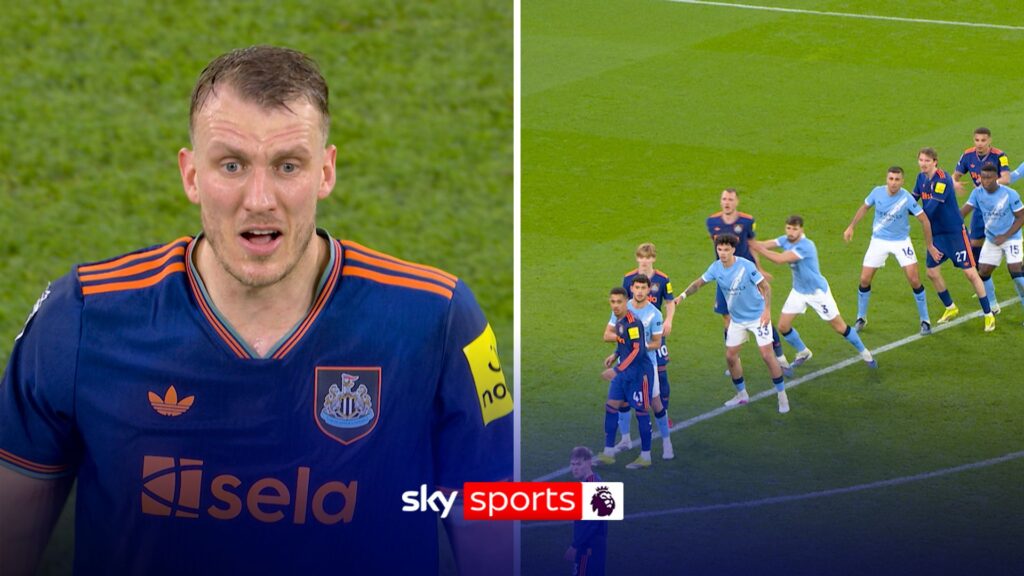 Ruben Dias jostling with Dan Burn in the penalty area during Manchester City vs Newcastle United