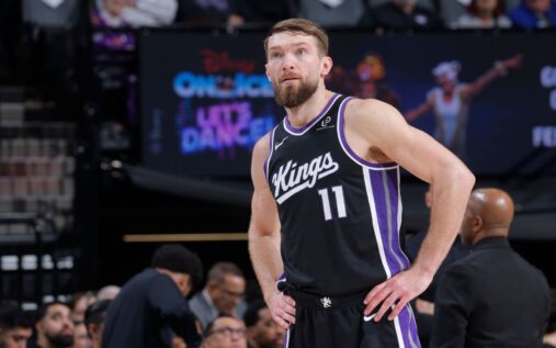 Sacramento Kings players Domantas Sabonis and Zach LaVine standing on the court during an NBA game