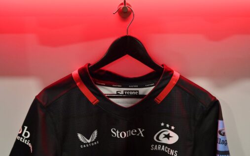 Saracens players gather in a huddle on the pitch during a Premiership rugby match