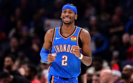 Shai Gilgeous-Alexander dribbling the ball for Oklahoma City Thunder during an NBA game
