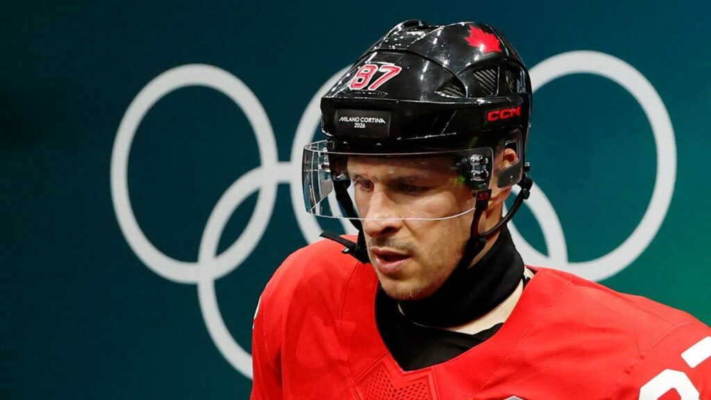 Sidney Crosby appearing in pain on the team bench while receiving medical attention during the Olympic quarter-final against Czechia