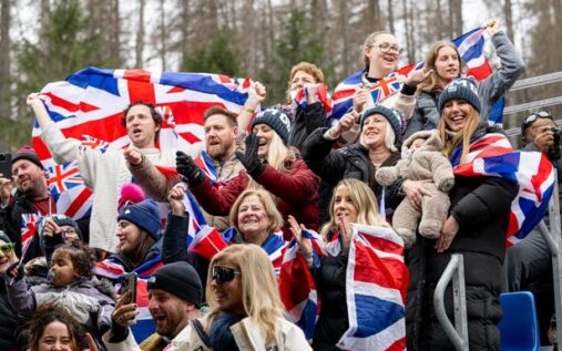 Team GB bobsleigh team celebrating with medals at Gatwick Airport after returning from Milano Cortina 2026.