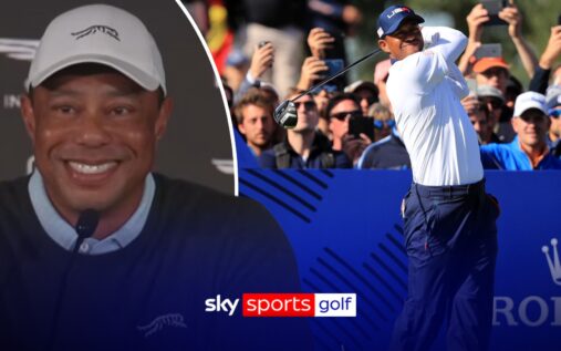 Tiger Woods looking thoughtful while wearing a cap and golf attire during a press conference