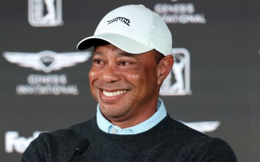 Tiger Woods looking focused while watching a tee shot during a practice round