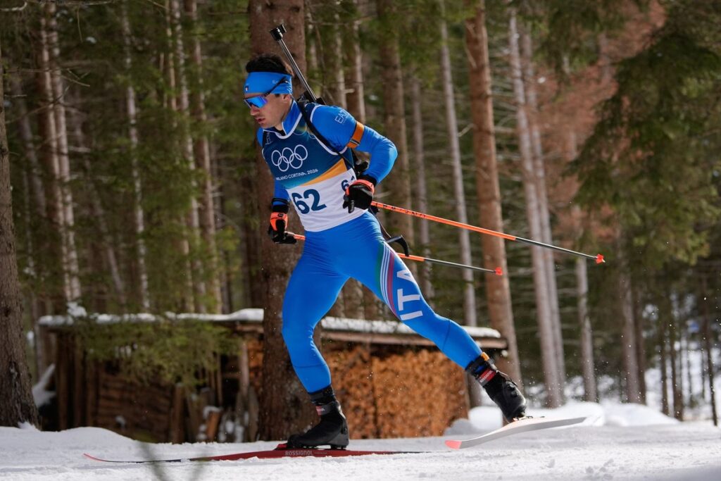 Tommaso Giacomel competing in a biathlon event wearing Italian national team kit
