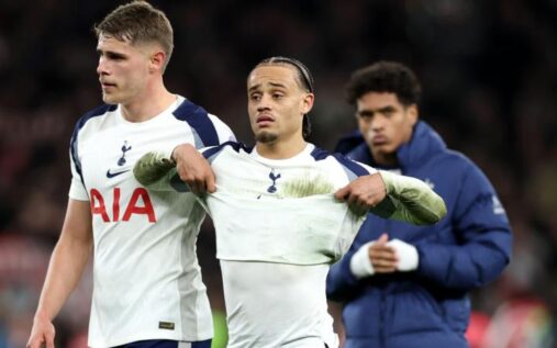 Tottenham Hotspur players look dejected on the pitch after conceding a goal against Arsenal in the north London derby