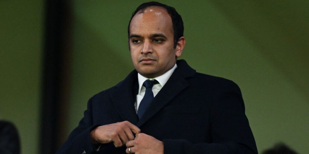 Gareth Southgate looking contemplative on the touchline while wearing a suit and tie during a match