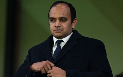 Gareth Southgate looking contemplative on the touchline while wearing a suit and tie during a match