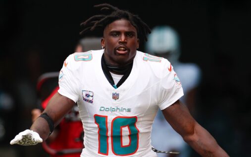 Tyreek Hill looking focused while wearing a Miami Dolphins uniform during an NFL game