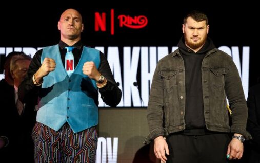 Tyson Fury pointing a gloved fist towards the camera during a press conference