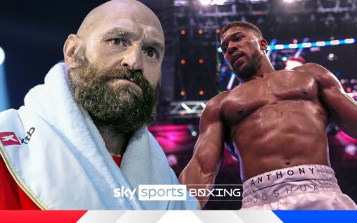 Frank Warren speaking at a press conference with Tyson Fury in the background