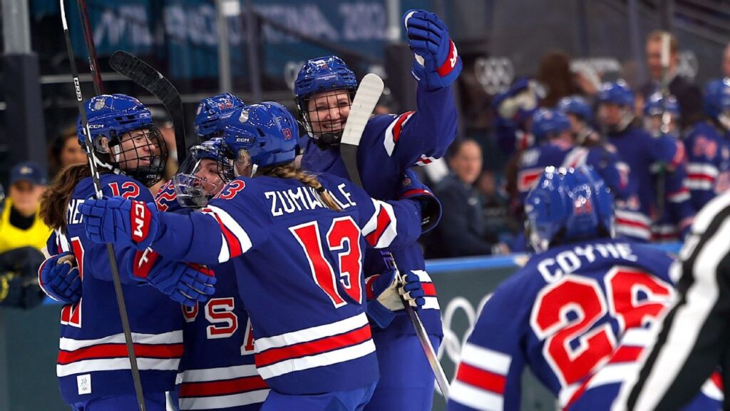 US women's hockey players celebrating a goal against Sweden at the Milan Cortina Winter Olympics