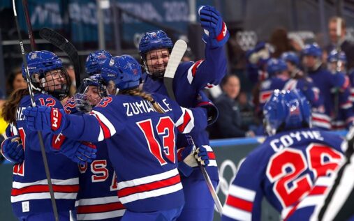 US women's hockey players celebrating a goal against Sweden at the Milan Cortina Winter Olympics