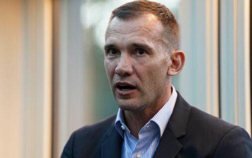 Andriy Shevchenko looking serious during a press conference wearing a dark suit