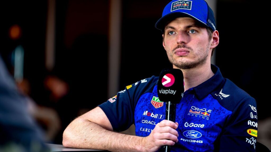 Max Verstappen speaking to the media in Red Bull Racing teamwear