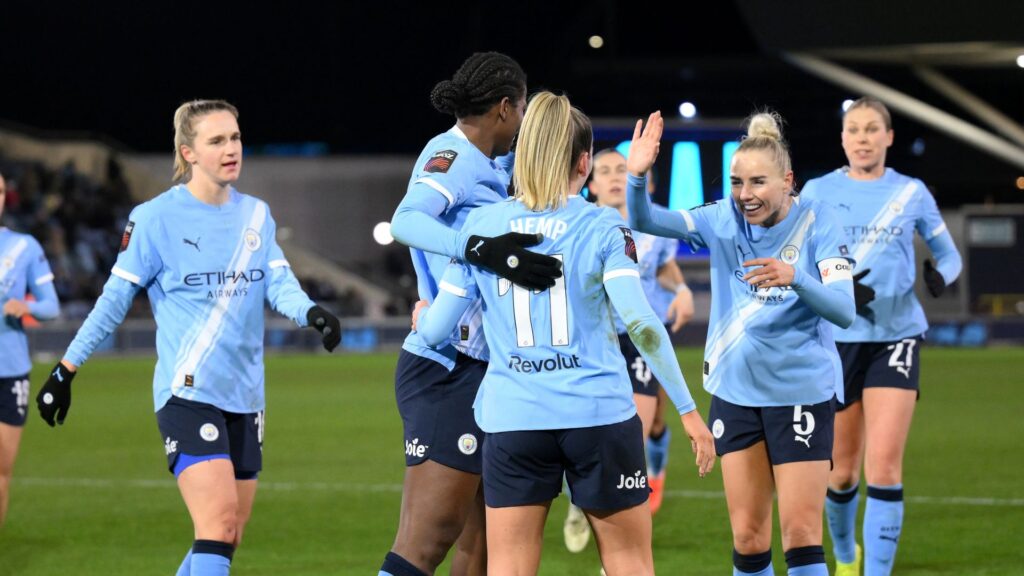 Manchester City players celebrating a goal against Leicester City in the Women's Super League