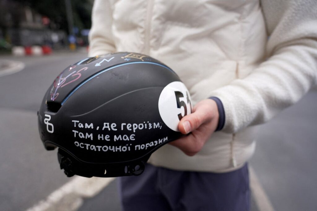 Ukrainian speed skater Oleh Handei holding his helmet at the Winter Olympics venue