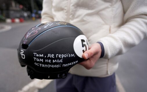 Ukrainian speed skater Oleh Handei holding his helmet at the Winter Olympics venue