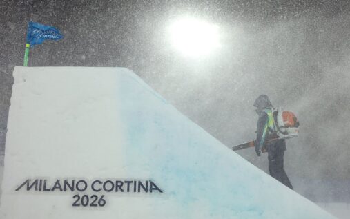 Ground staff clearing heavy snow from a ski slope during a blizzard at the Winter Olympics in Livigno