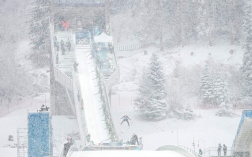 A snow groomer clearing heavy snow from the halfpipe course in Livigno during the Winter Olympics