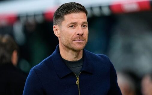 Xabi Alonso issuing instructions from the technical area while wearing a dark suit