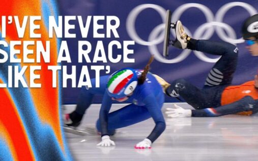 Yang Jingru skating alone on the ice while rivals slide into the crash pads in the background during the 1500m semi-final
