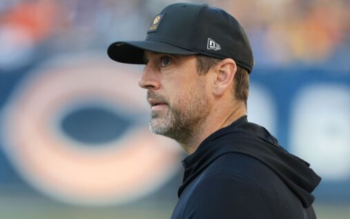 Aaron Rodgers looking contemplative while wearing a Pittsburgh Steelers uniform during a game
