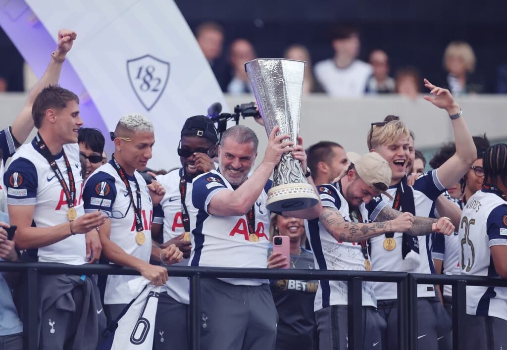 Ange Postecoglou holding the Europa League trophy during the Tottenham Hotspur victory parade