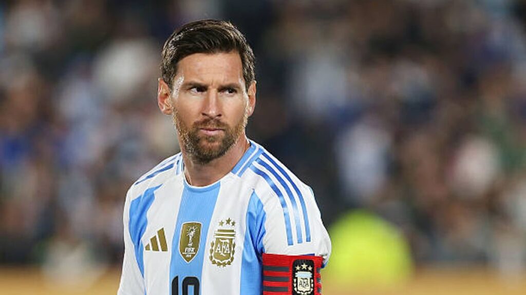 Lionel Messi looking thoughtful while wearing the Argentina national team kit on the pitch