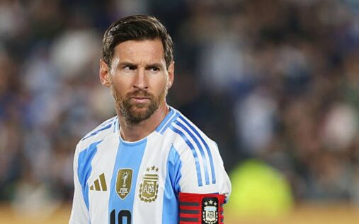 Lionel Messi looking thoughtful while wearing the Argentina national team kit on the pitch