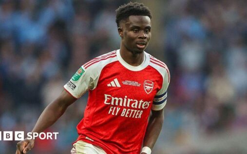 Bukayo Saka looking dejected on the pitch during an Arsenal match