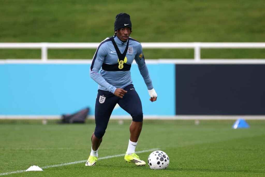 Noni Madueke playing for England in a white international kit
