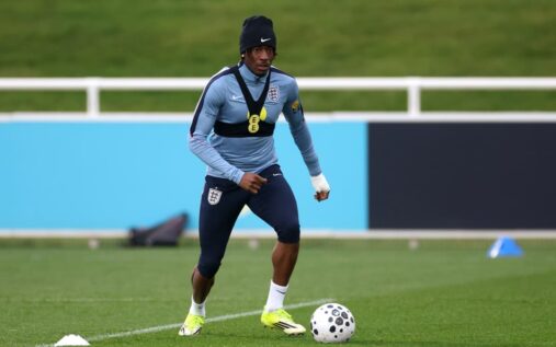 Noni Madueke playing for England in a white international kit