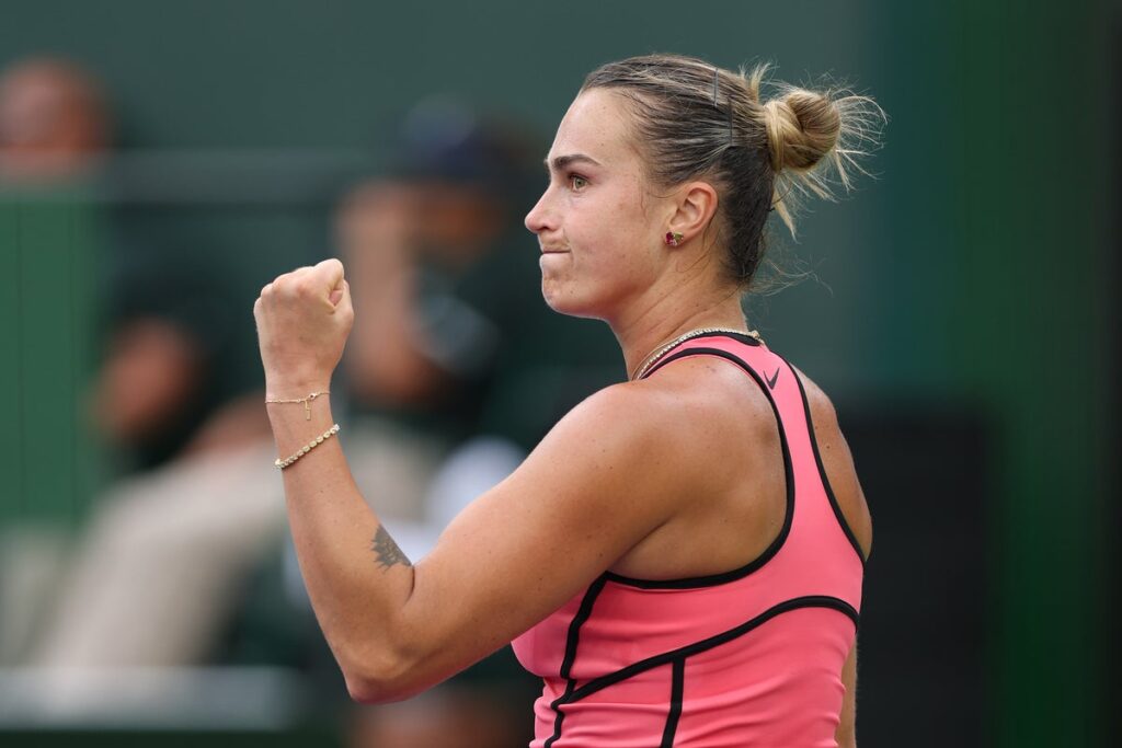 Aryna Sabalenka hitting a powerful serve during an Indian Wells match