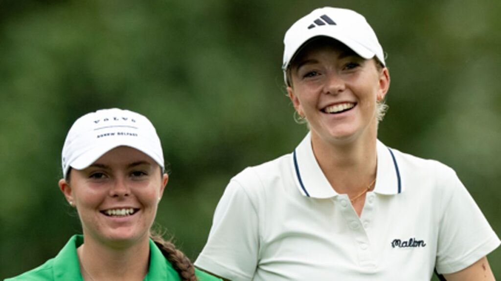 Female amateur golfer hitting an approach shot on the fairway at Augusta National