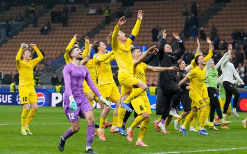 Bodo/Glimt players celebrating a Champions League victory on the artificial pitch at Aspmyra Stadium
