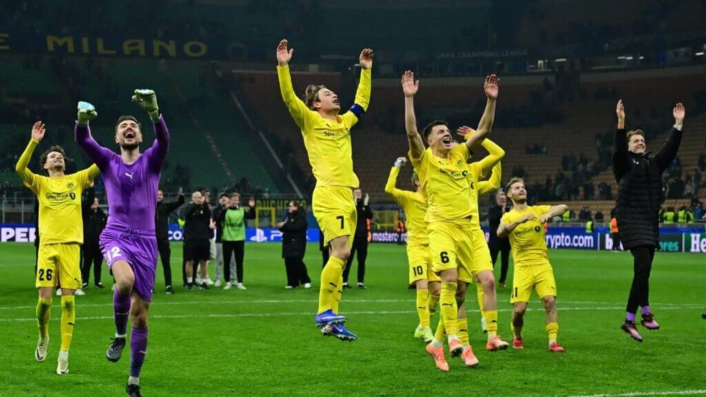 Bodo/Glimt players celebrating a famous Champions League victory on the pitch
