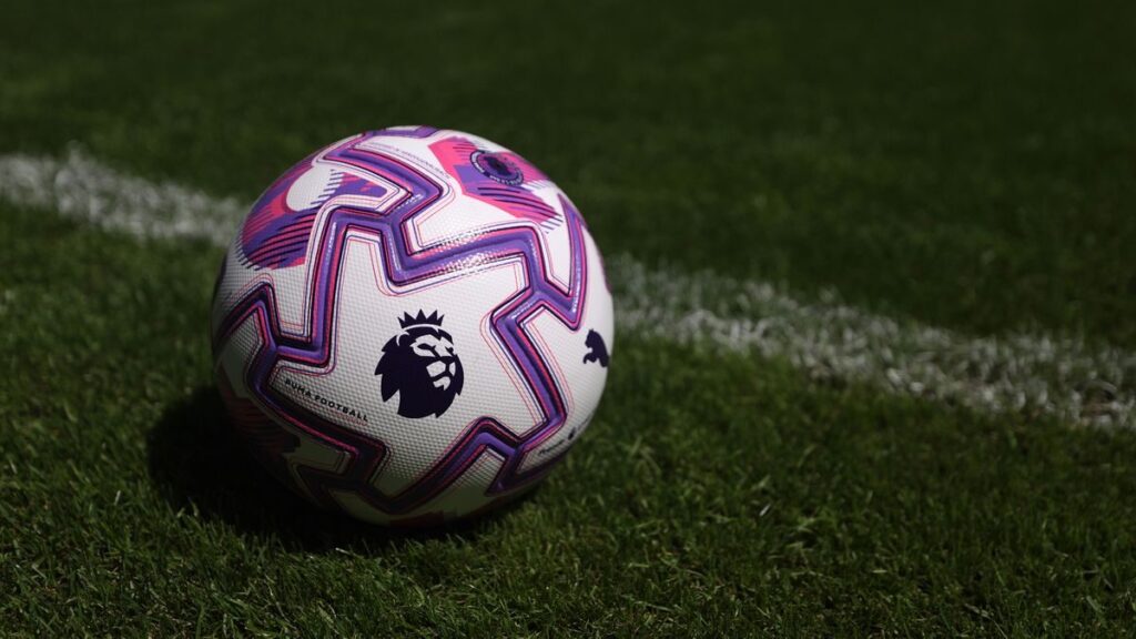 Brentford football players standing together on the pitch during a Premier League match