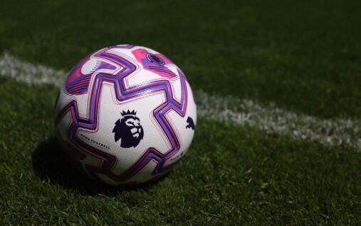 Brentford football players standing together on the pitch during a Premier League match