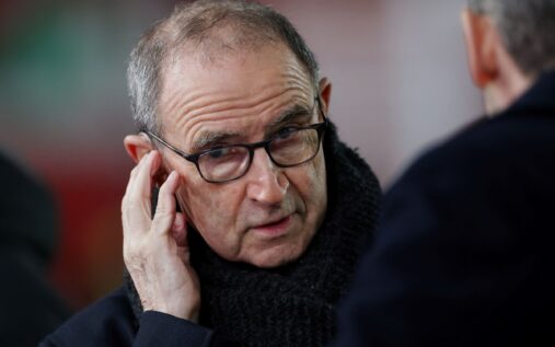 Kasper Schmeichel wearing a Celtic goalkeeper kit looking dejected on the pitch