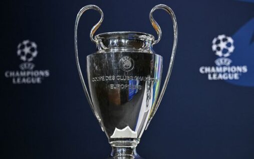 The UEFA Champions League trophy displayed under stadium floodlights