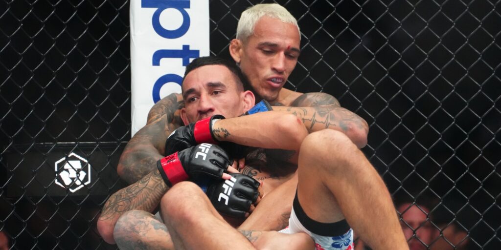 Charles Oliveira celebrating his decision victory over Max Holloway at UFC 326