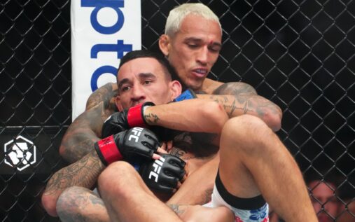 Charles Oliveira celebrating his decision victory over Max Holloway at UFC 326