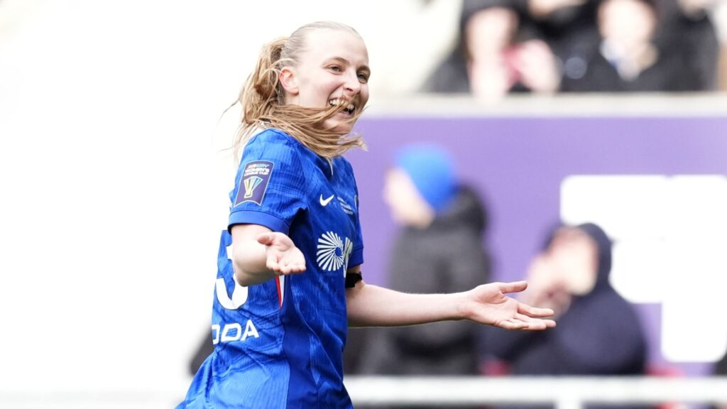 Chelsea players celebrating with the Women's League Cup trophy after beating Manchester United