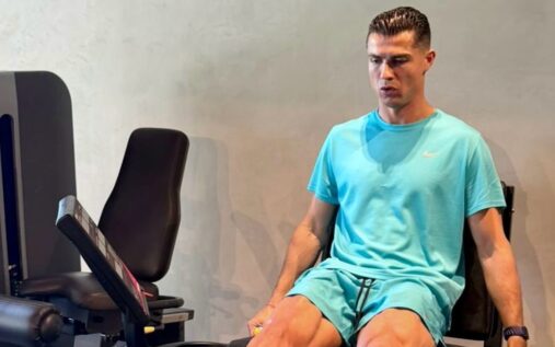 Cristiano Ronaldo wearing a turquoise sports set while working out on a leg press machine in the gym