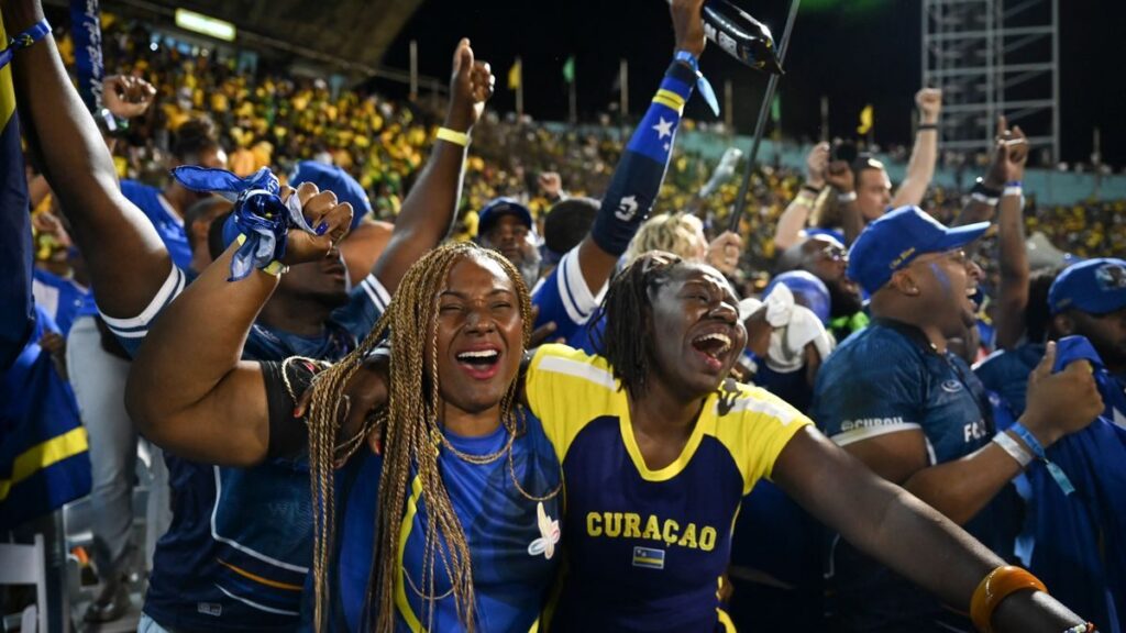 Kenji Gorre celebrating in a Curacao national team football kit on the pitch