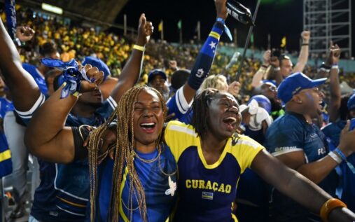 Kenji Gorre celebrating in a Curacao national team football kit on the pitch